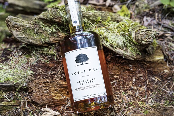 This image provided by Noble Oak shows a 750ml bottle of Noble Oak bourbon. For every bottle sold, the company plants a tree in partnership with One Tree Planted, a Vermont-based reforestation nonprofit. (Noble Oak via AP)