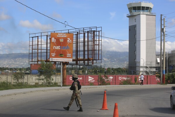 A police officer patrols the entrance of the Toussaint Louverture International Airport, in Port-au-Prince, Haiti, Nov. 12, 2024. (AP Photo/Odelyn Joseph, File)