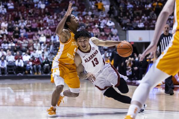 Alabama guard Jahvon Quinerly (13) works his way inside against Tennessee guard Zakai Zeigler (5) during the second half of an NCAA college basketball game Wednesday, Dec. 29, 2021, in Tuscaloosa, Ala. (AP Photo/Vasha Hunt)