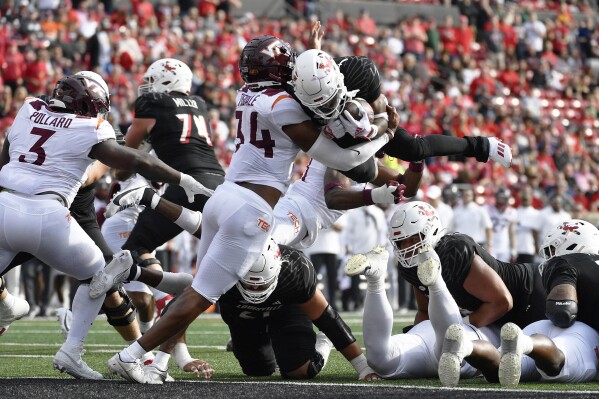 Virginia Tech linebacker Alan Tisdale (34) attempts to keep Louisville running back Jawhar Jordan (25) from the end zone during the first half of an NCAA college football game in Louisville, Ky., Saturday, Nov. 4, 2023. (AP Photo/Timothy D. Easley)