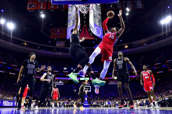 Philadelphia 76ers' Tobias Harris (12) shoots over Brooklyn Nets' Spencer Dinwiddie (26) in the second half during Game 1 in the first round of the NBA basketball playoffs, Saturday, April 15, 2023, in Philadelphia. (AP Photo/Derik Hamilton)