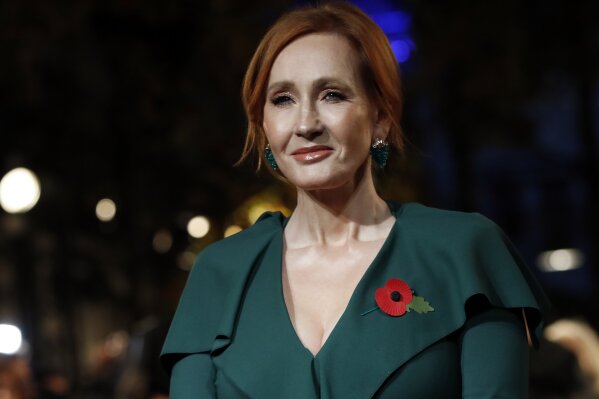 FILE - In this Thursday, Nov. 8, 2018 file photo, writer J.K. Rowling poses for the media at the world premiere of the film "Fantastic Beasts: The Crimes of Grindelwald" in Paris. Rowling announced on Friday, Aug. 28, 2020 she is returning an award from a human rights group linked to the Kennedy family after the president of the organization criticized her comments about transgender issues. Rowling’s decision comes after Kerry Kennedy, the president of Robert F. Kennedy Human Rights and the late senator’s daughter, published a statement expressing her “profound disappointment” with the author’s comments. (AP Photo/Christophe Ena, file)