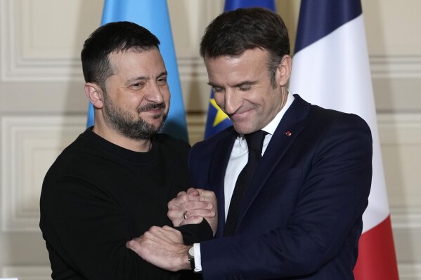 Ukrainian President Volodymyr Zelenskyy, left, and French President Emmanuel Macron shake hands after a press conference, Friday, Feb. 16, 2024 at the Elysee Palace in Paris. Ukrainian President Volodymyr Zelenskyy arrived in Paris to sign a bilateral security agreement with France hours after he officialized a similar one with Germany. The agreements send a strong signal of long-term backing as Kyiv works to shore up Western support nearly two years after Russia launched its full-scale war. (AP Photo/Thibault Camus, Pool)