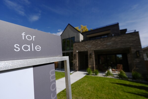 A sale sign stands outside a home on the market Thursday, Oct. 17, 2024, in the east Washington Park neighborhood of Denver. (AP Photo/David Zalubowski, File)