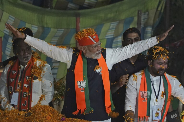 FILE - Indian Prime Minister Narendra Modi greets supporters as he arrives for an election campaign rally of his Bharatiya Janata Party (BJP) in Hyderabad, India, Monday, Nov. 27, 2023. (AP Photo/Mahesh Kumar A., File)