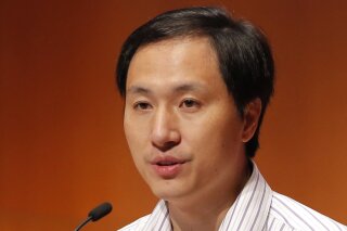 FILE - In this Nov. 28, 2018, file photo, He Jiankui, a Chinese researcher, speaks during the Human Genome Editing Conference in Hong Kong. Chinese scientist He Jiankui shocked the world by claiming he had helped make the first gene-edited babies. One year later, mystery surrounds his fate as well as theirs. He has not been seen publicly since January, his work has not been published and nothing is known about the health of the babies.  (AP Photo/Kin Cheung, File)