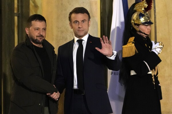 French President Emmanuel Macron, right, welcomes his Ukrainian counterpart, Volodymyr Zelenskyy Friday, Feb. 16, 2024 at the Elysee Palace in Paris. French President Emmanuel Macron will sign a bilateral security agreement with his Ukrainian counterpart, Volodymyr Zelenskyy to provide "long-term support" to the war-ravaged country which has been battling Russia's full-scale invasion for nearly two years. (AP Photo/Christophe Ena)