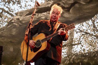 FILE - This June 15, 2019 file photo shows John Prine performing at the Bonnaroo Music and Arts Festival in Manchester, Tenn.  Prine died Tuesday, April 7, 2020, from complications of the coronavirus. He was 73.  (Photo by Amy Harris/Invision/AP, File)