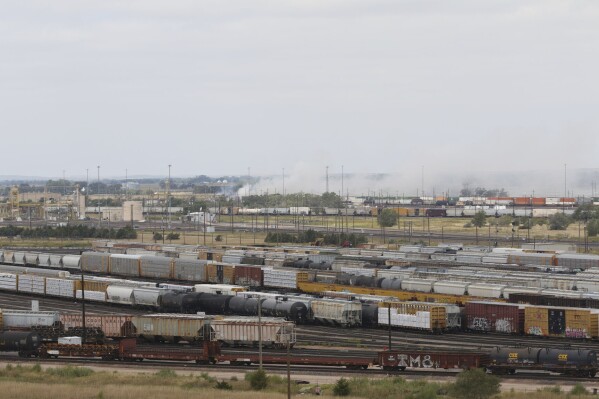 FILE - Smoke emanates from a railroad car after an explosion at Union Pacific's Bailey Yard, Sept. 14, 2023, in North Platte, Neb. The explosion of a shipping container filled with toxic acid inside the world’s largest railyard, combined with hundreds of rules violations inspectors found there, raises questions about Union Pacific's safety and the effectiveness of the rules for shipping hazardous materials. The Sept. 14 blast fortunately happened in a remote corner of the railyard and the resulting fire did not spread widely. (Ryan Herzog/The Telegraph via AP, File)