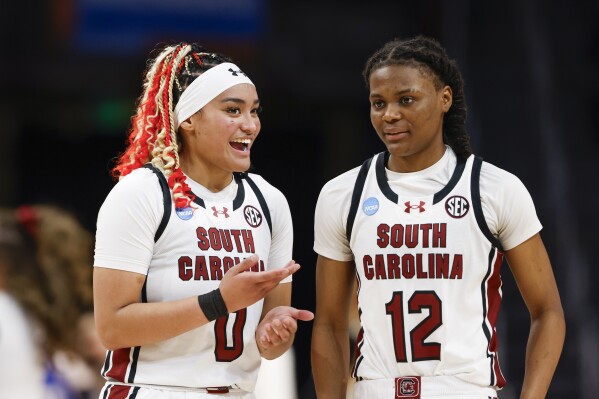South Carolina guards Te-Hina Paopao, left, and MiLaysia Fulwiley talk during a break in the second half of a first-round college basketball game against Presbyterian in the women's NCAA Tournament in Columbia, S.C., Friday, March 22, 2024. (AP Photo/Nell Redmond)