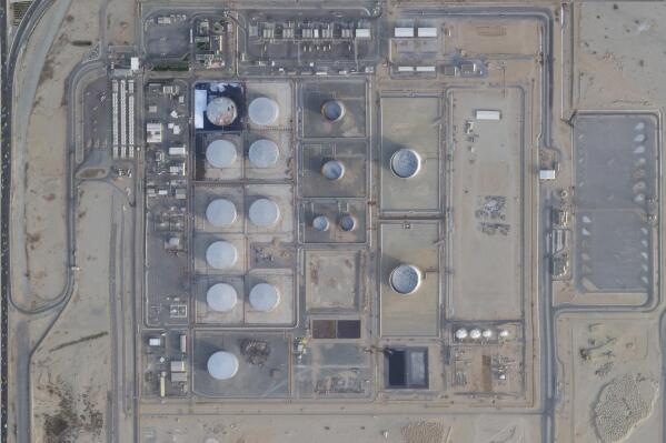 In this satellite photo from Planet Labs PBC, damage is seen after an attack by Yemen's Houthi rebels targeting Saudi Aramco's North Jiddah Bulk Plant in Jiddah, Saudi Arabia, Tuesday, March 22, 2022. Yemen's Houthi rebels this week struck the exact same oil storage tank in the Saudi Arabian city of Jiddah that they previously hit some two years earlier, satellite photos show. (Planet Labs PBC via AP)