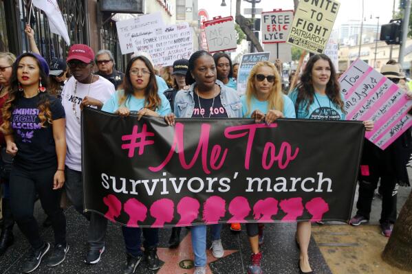 FILE - In this Nov. 1, 2017 file photo, participants march against sexual assault and harassment during the #MeToo March in the Hollywood section of Los Angeles. At center is Tarana Burke, founder of the #MeToo movement. According to a 2021 The Associated Press-NORC Center for Public Affairs Research poll, just over half of Americans - 54% - say they personally are more likely to speak out if they're a victim of sexual misconduct. (AP Photo/Damian Dovarganes, File)