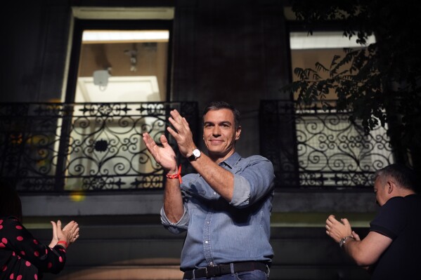 Socialist Workers' Party leader and current Prime Minister Pedro Sanchez greets supporters outside the party's headquarters in Madrid, Spain, Sunday July 23, 2023. Spain's conservative Popular Party is set to narrowly win the country's national election but without the majority needed to topple the coalition government of Socialist Prime Minister Pedro Sánchez. (AP Photo/Emilio Morenatti)