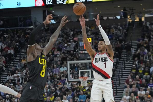 Portland Trail Blazers guard Anfernee Simons (1) shoots as Utah Jazz forward Jarred Vanderbilt (8) defends during the first half of an NBA basketball game Saturday, Dec. 3, 2022, in Salt Lake City. (AP Photo/Rick Bowmer)