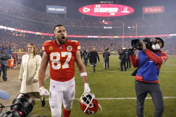 Kansas City Chiefs offensive coordinator Eric Bieniemy talks to Chiefs  tight end Travis Kelce (87) after their win over the Buffalo Bills in an NFL  divisional playoff football game, Sunday, Jan. 23