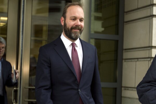FILE - In this Feb. 23, 2018 file photo, Rick Gates leaves federal court in Washington. Federal prosecutors are asking a judge to set a sentencing date for next month for former Trump campaign official Gates. The request on Monday, Nov. 11, 2019, is a sign that Gates’ extensive cooperation with the government is coming to an end. (AP Photo/Jose Luis Magana)