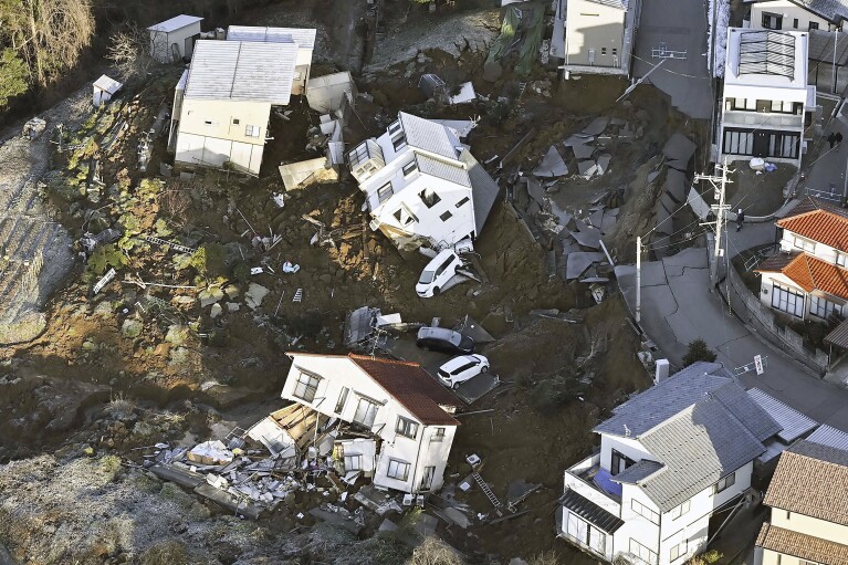 Houses leveled by an earthquake are seen in Kanazawa, Ishikawa prefecture, Japan Tuesday, Jan. 2, 2024. (Kyodo News via AP)
