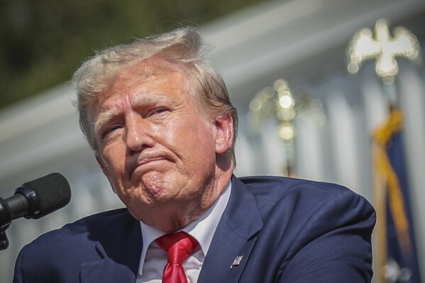 FILE - Former President Donald Trump pauses before concluding his remarks at a rally in Summerville, S.C. on September 25, 2023.  A judge's ruling that Trump committed fraud as he built his real estate empire tarnishes the former president's image as a business titan.  He could be stripped of his authority to make key decisions about the future of his market property in his home state.  (AP Photo/RT Walker Jr., File)