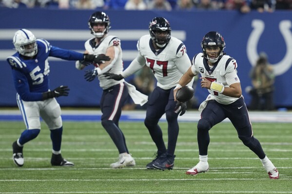 Houston Texans quarterback C.J. Stroud, right, runs during the second half of an NFL football game against the Indianapolis Colts, Saturday, Jan. 6, 2024, in Indianapolis. (AP Photo/Darron Cummings)