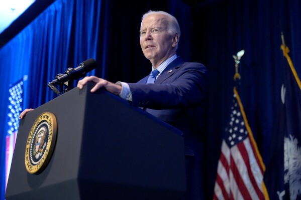 FILE - President Joe Biden speaks at South Carolina's First in the Nation dinner at the South Carolina State Fairgrounds in Columbia, S.C., Jan. 27, 2024. The Biden administration will start implementing a new requirement that the developers of major artificial intelligence systems disclose their safety test results to the government. (AP Photo/Jacquelyn Martin, File)