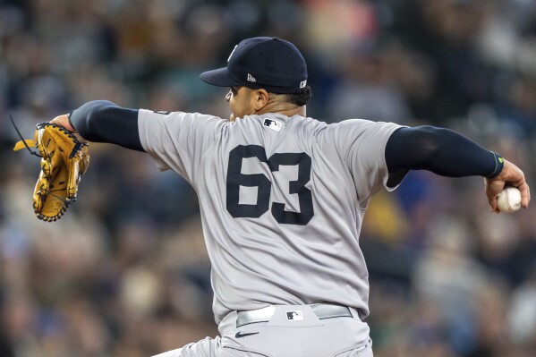 New York Yankees reliever Fernando Cruz delivers a pitch during the eighth inning of a baseball game against the Seattle Mariners, Wednesday, May 14, 2025, in Seattle. (AP Photo/Stephen Brashear)