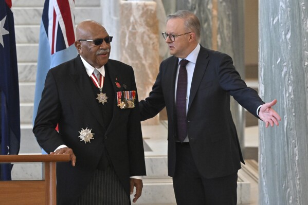 Fiji's Prime Minister Sitiveni Rabuka, left, and Australian Prime Minister Anthony Albanese talk after signing the visitors' book at Parliament House in Canberra, Wednesday, Oct. 18, 2023. Rabuka said his government was 