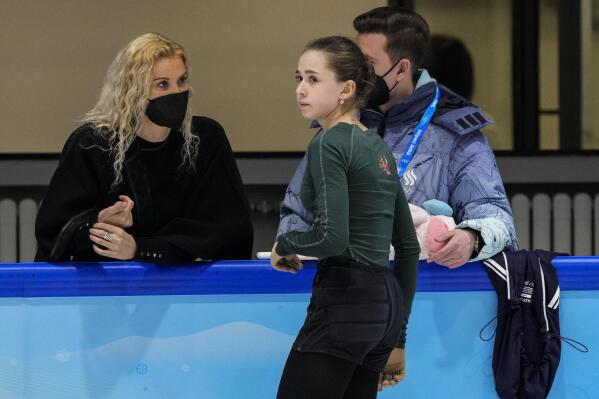 Coach Eteri Tutberidze, left, talks to Kamila Valieva, of the Russian Olympic Committee, during a training session at the 2022 Winter Olympics, Saturday, Feb. 12, 2022, in Beijing. (AP Photo/Bernat Armangue)