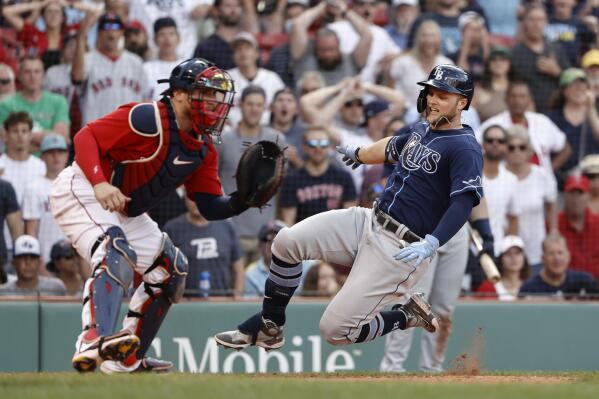 Tampa Bay Rays' Austin Meadows, right, slides safely home with an inside-the-park home run as Boston Red Sox catcher Christian Vazquez, left, waits for the throw during the ninth inning of a baseball game Monday, Sept. 6, 2021, at Fenway Park in Boston. (AP Photo/Winslow Townson)