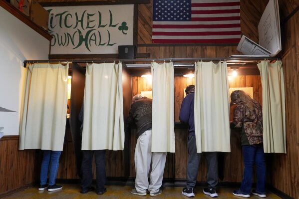 Voters mark their ballots at a polling place, Nov. 5, 2024, in Mitchell, Wis. (AP Photo/Morry Gash, File)