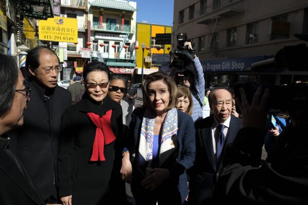 Speaker of the House Nancy Pelosi, D-Calif., walks with Florence Fang, second from left, to a temple during a tour of Chinatown Monday, Feb. 24, 2020, in San Francisco. Speaker Pelosi chatted with shop owners and took a walking tour of San Francisco's Chinatown in an effort to let people know the neighborhood is safe and would welcome their support. (AP Photo/Eric Risberg)