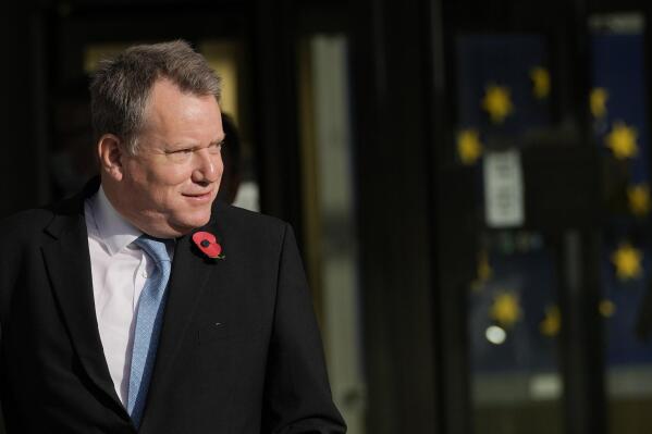 FILE - Britain's chief Brexit negotiator David Frost arrives for a media statement at EU headquarters in Brussels, Nov. 5, 2021. Britain’s top Brexit official has lowered the temperature in the U.K.’s trade feud with the European Union, saying he believes it is possible to reach agreement with the bloc. Chief U.K. negotiator David Frost said Wednesday, Nov, 17 there are still “gaps” between the two sides, but added that he thinks a deal can be done.  (AP Photo/Virginia Mayo, file)