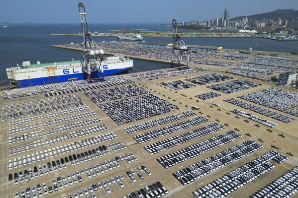 New vehicles for export is seen piled up on a dockyard in Yantai in east China's Shandong province on July 5, 2023. China's exports tumbled in June by 12.4% compared with a year earlier amid weaker global demand and higher inflation. (Chinatopix Via AP)