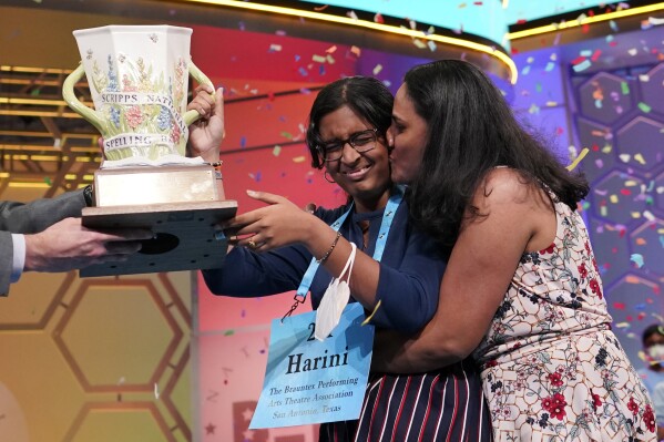 FILE - Harini Logan, 14, from San Antonio, Texas, gets a kiss from her mom Rampriya Logan on stage as she celebrates winning the Scripps National Spelling Bee, Thursday, June 2, 2022, in Oxon Hill, Md. Since 1999, 28 of the last 34 Scripps National Spelling bee champions have been Indian American. The experiences of first-generation Indian Americans and their spelling bee champion children illustrate the economic success and cultural impact of the nation’s second-largest immigrant group. (AP Photo/Alex Brandon, File)
