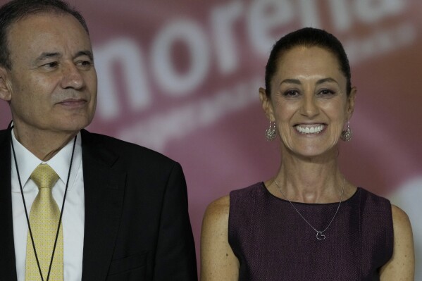 Mexican politicians Alfonso Durazo, left, and presumptive MORENA party presidential candidate Claudia Sheinbaum stand together during an event to announce the next party candidate in Mexico City, Wednesday, Sept. 6, 2023. (AP Photo/Fernando Llano)