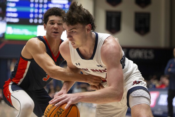 Saint Mary's guard Alex Ducas, right, drives past Pepperdine guard Malik Moore (3) during the first half of an NCAA college basketball game, Thursday, Feb. 15, 2024, in Moraga, Calif. (AP Photo/D. Ross Cameron)