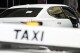 An Uber vehicle stops across the road from a taxi rank in Sydney, Monday, March 18, 2024. Global rideshare giant Uber will pay 272 million Australian dollars ($178 million) to settle a long-running dispute with Australian taxi and hire car drivers who lost out when the company entered the Australian market. (AP Photo/Rick Rycroft)