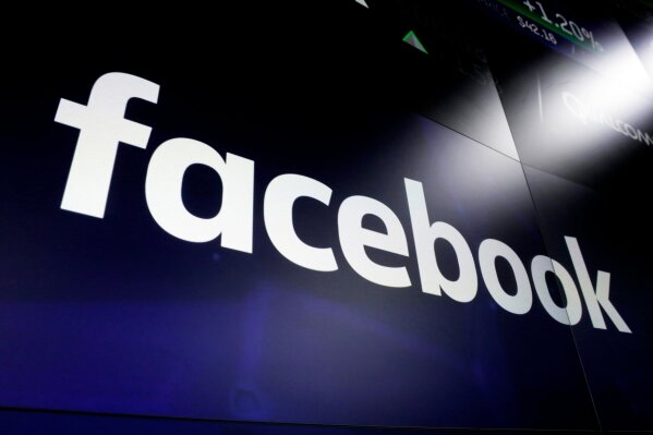 FILE - This March 29, 2018 file photo, shows the logo for social media giant Facebook at the Nasdaq MarketSite in New York's Times Square. Britain's competition watchdog signalled on Wednesday Dec. 18, 2019, its willingness to push for stricter rules to counter Google and Facebook 's dominance of online advertising. (AP Photo/Richard Drew, File)