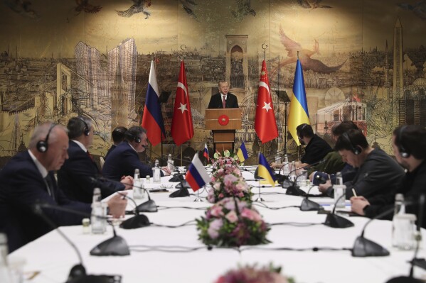 In this photo provided by the Turkish Presidency, Turkish President Recep Tayyip Erdogan, center, gives a speech to welcome the Russian, left, and Ukrainian delegations ahead of their talks in Istanbul, Turkey, on March 29, 2022. (Turkish Presidency via AP, File)