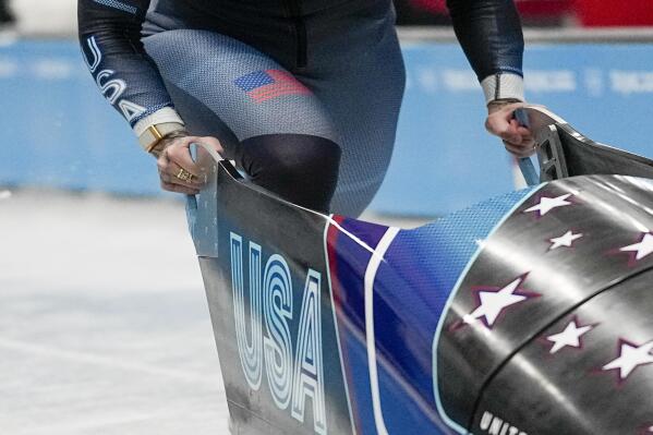 Kaillie Humphries, of United States, drives during the women's monobob heat 1 at the 2022 Winter Olympics, Sunday, Feb. 13, 2022, in the Yanqing district of Beijing. (AP Photo/Pavel Golovkin)