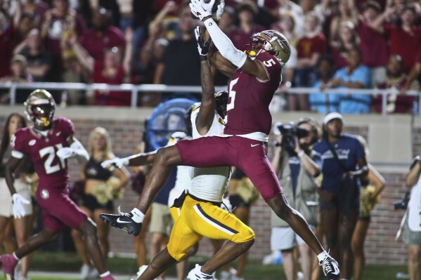 Florida State wide receiver Deuce Spann (5) leaps for a catch but Southern Mississippi cornerback Markel McLaurin knocks the ball away in the first quarter of an NCAA college football game Saturday, Sept. 9, 2023, in Tallahassee, Fla. (AP Photo/Phil Sears)