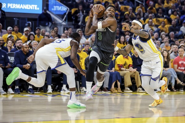 Anthony Edwards (5) of Minnesota Timberwolves drives to the basket between Gary Payton II (0) and Draymond Green (23) of Golden State Warriors in the first half of Game 3 of the Conference Semifinals of the NBA Playoffs at Chase Center in San Francisco., on Saturday, May 10, 2025. (Carlos Avila Gonzalez/San Francisco Chronicle via AP)