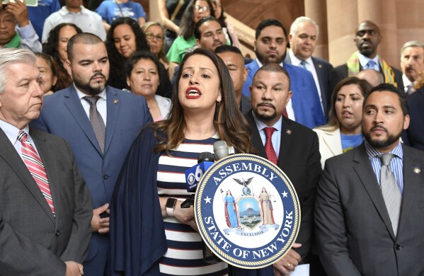 Asemblywoman Catalina Cruz, D- Jackson Heights, center, speaks in favor of legislation for the Green Light Bill granting undocumented Immigrant driver's licenses during a rally at the state Capitol Monday, June 17, 2019, in Albany, N.Y. (AP Photo/Hans Pennink, File)