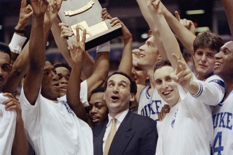 FILE - Duke coach Mike Krzyzewski and his team celebrate after defeating Michigan 71-51 in the NCAA college basketball Final Four championship game on April 7, 1992 in Minneapolis.  (AP Photo/Jim Mone, File)