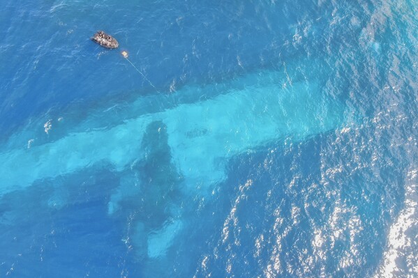 In this photo provided by the New Zealand Defence Force, divers survey the area around HMNZS Manawanui on the southern coast of Upulo, Samoa, after the Manawanui ran aground and sank on Oct. 6. (AC Jese Somerville/New Zealand Defence Force via AP, File)