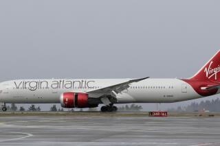 A Virgin Atlantic Airways plane taxis, April 13, 2018, at the Seattle-Tacoma International Airport in Seattle. The U.S. Transportation Department has fined British airline Virgin Atlantic up to $1.05 million for flying over restricted airspace in Iraq while operating flights in a partnership with Delta Air Lines. (AP Photo/Ted S. Warren)