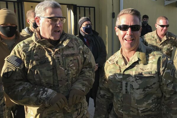 Chairman of the U.S. Joint Chiefs of Staff Gen. Mark Milley, left, talks with Gen. Scott Miller, the commander of U.S. and coalition forces in Afghanistan, Wednesday, Dec. 16, 2020 at Miller’s military headquarters in Kabul, Afghanistan. The top U.S. military officer has held an unannounced meeting with Taliban peace negotiators to push for a reduction in violence in Afghanistan. (AP Photo/Robert Burns)