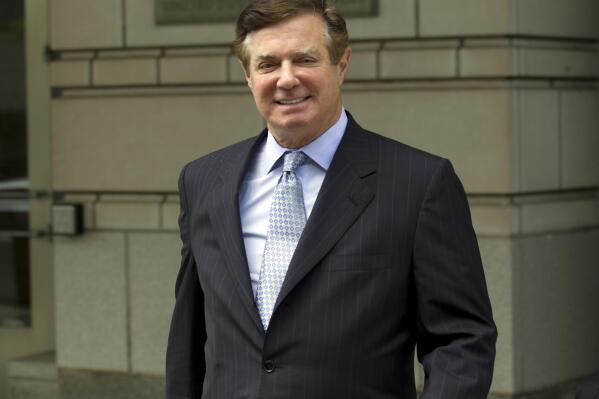 FILE - In this May 23, 2018, photo, Paul Manafort, President Donald Trump's former campaign chairman, leaves the Federal District Court after a hearing in Washington.  Manafort was removed from a plane at Miami International Airport before it took off for Dubai because he carried a revoked passport. Miami-Dade police confirmed Wednesday, March 23, 2022,  that Manafort was removed from the Emirates Airline flight without incident on Sunday night.  ( AP Photo/Jose Luis Magana)