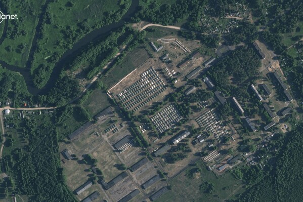 This satellite image provided by Planet Labs PBC and taken on Friday, June 30, 2023, shows apparent recent construction of tents at a former military base outside the Belarusian town of Osipovichi. As part of a deal to end a rebellion in Russia by Wagner Group mercenaries, Belarus’s president says he offered the fighters an abandoned military unit to set up camp and the leader of an exiled Belarusian guerrilla organization told The AP it is near Osipovichi. (Planet Labs PBC via AP)