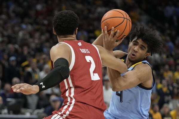 Wisconsin's Jordan Davis and Marquette's Stevie Mitchell go for a loose ball during the second half of an NCAA college basketball game Saturday, Dec. 3, 2022, in Milwaukee. Wisconsin won 80-77 in overtime. (AP Photo/Morry Gash)