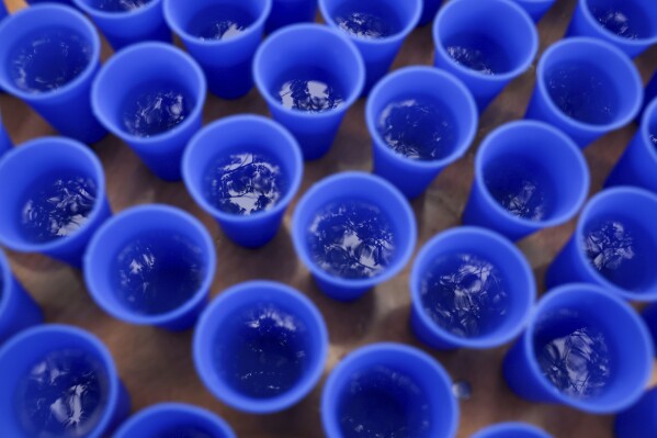 Water is available to runners in Hiccup, reusable silicone cups, during the PNC Women Run the Cities race on Saturday, May 17, 2025, in Minneapolis. (AP Photo/Ellen Schmidt)